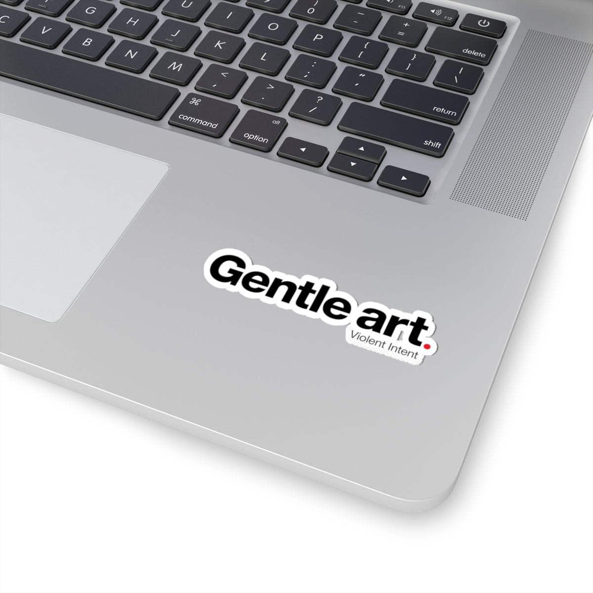 Laptop with a 'Gentle art, Violent Intent' sticker on the palm rest area.