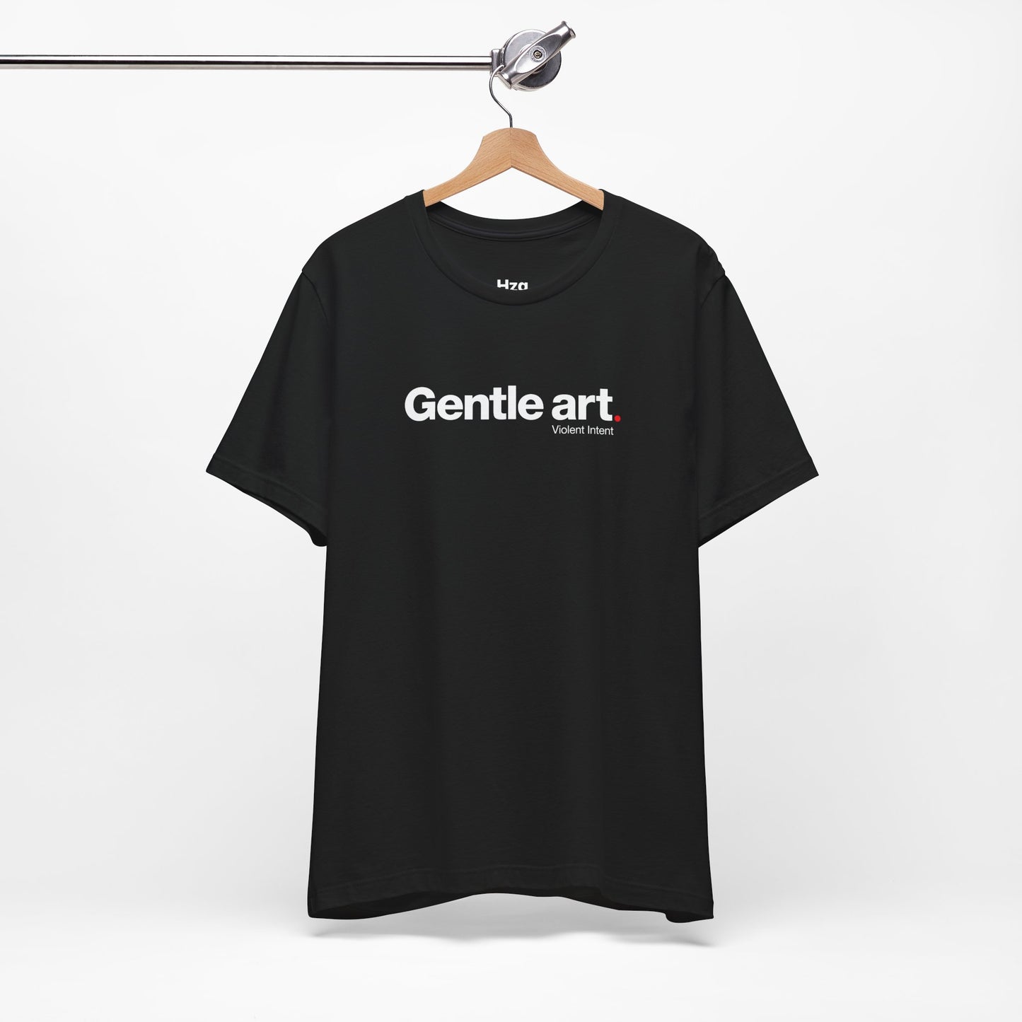 Black t-shirt with 'Gentle art' text on a hanger against a white background