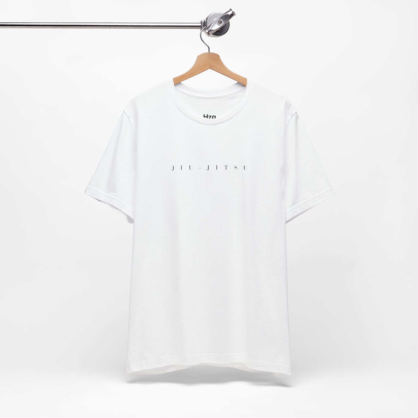 White t-shirt with text on a hanger against a white background