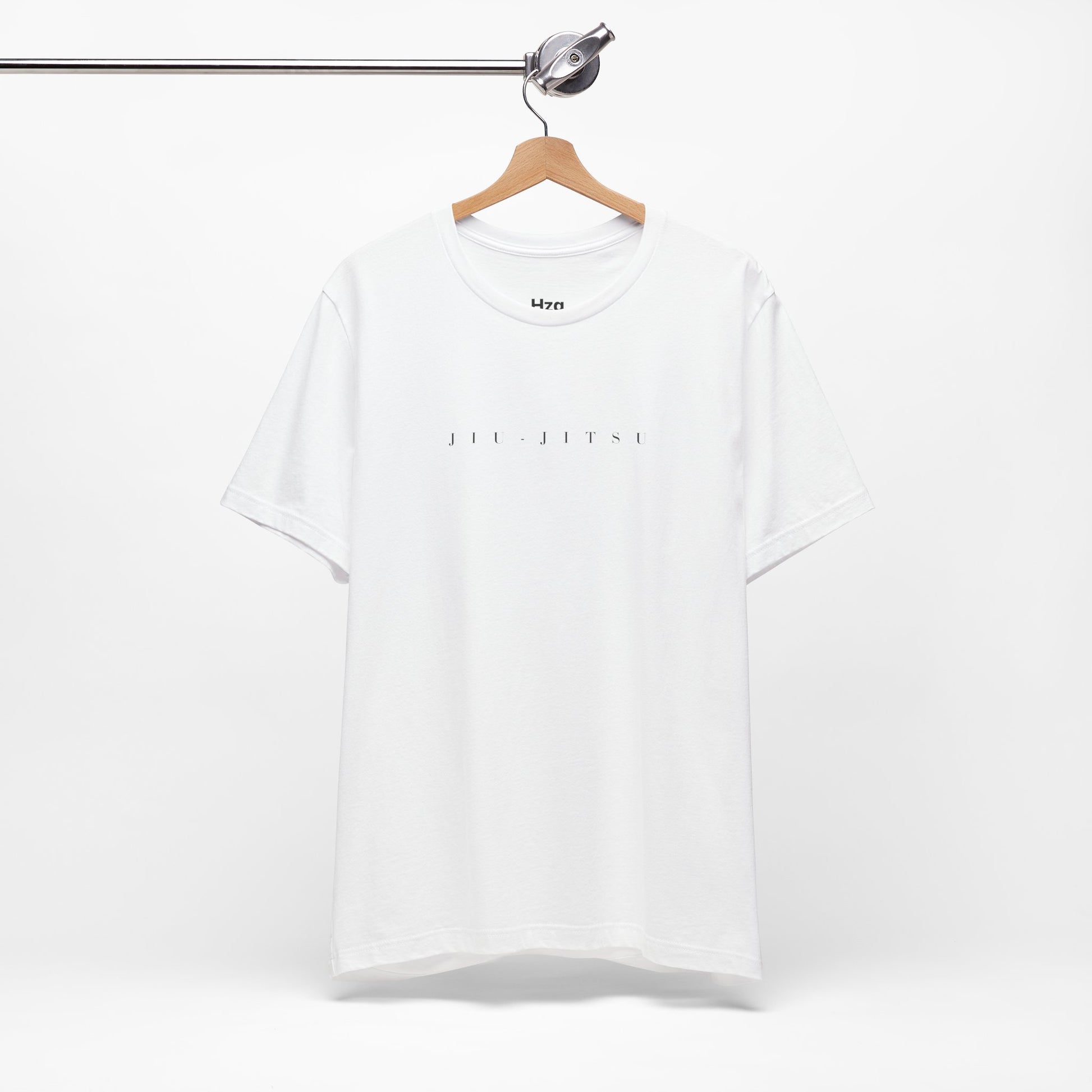 White t-shirt with text on a hanger against a white background