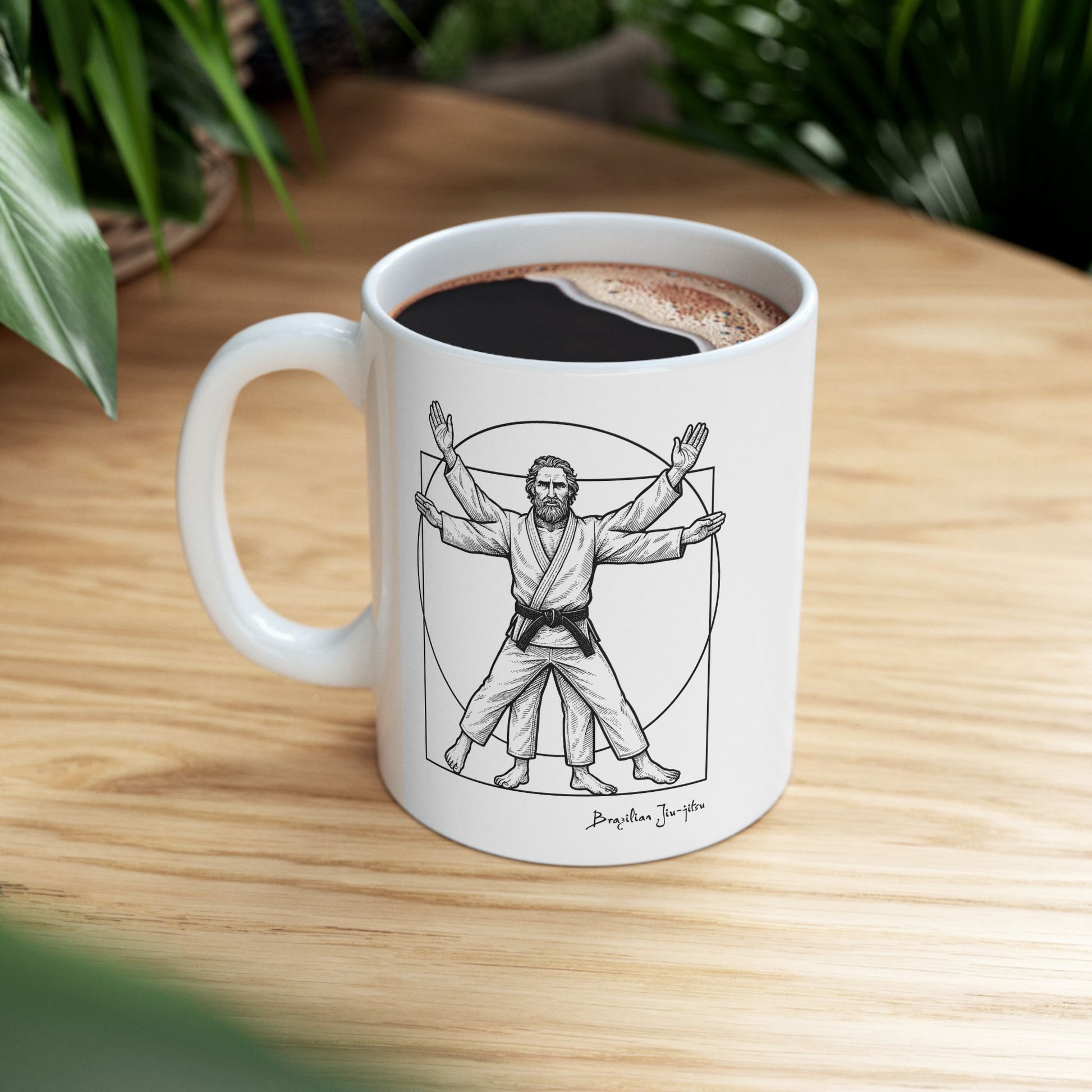 White mug with a Vitruvian Man design on a wooden table with coffee.