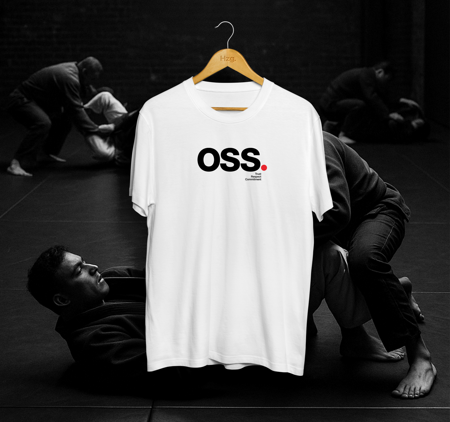 White t-shirt with 'OSS' logo on a hanger against a black background with people.
