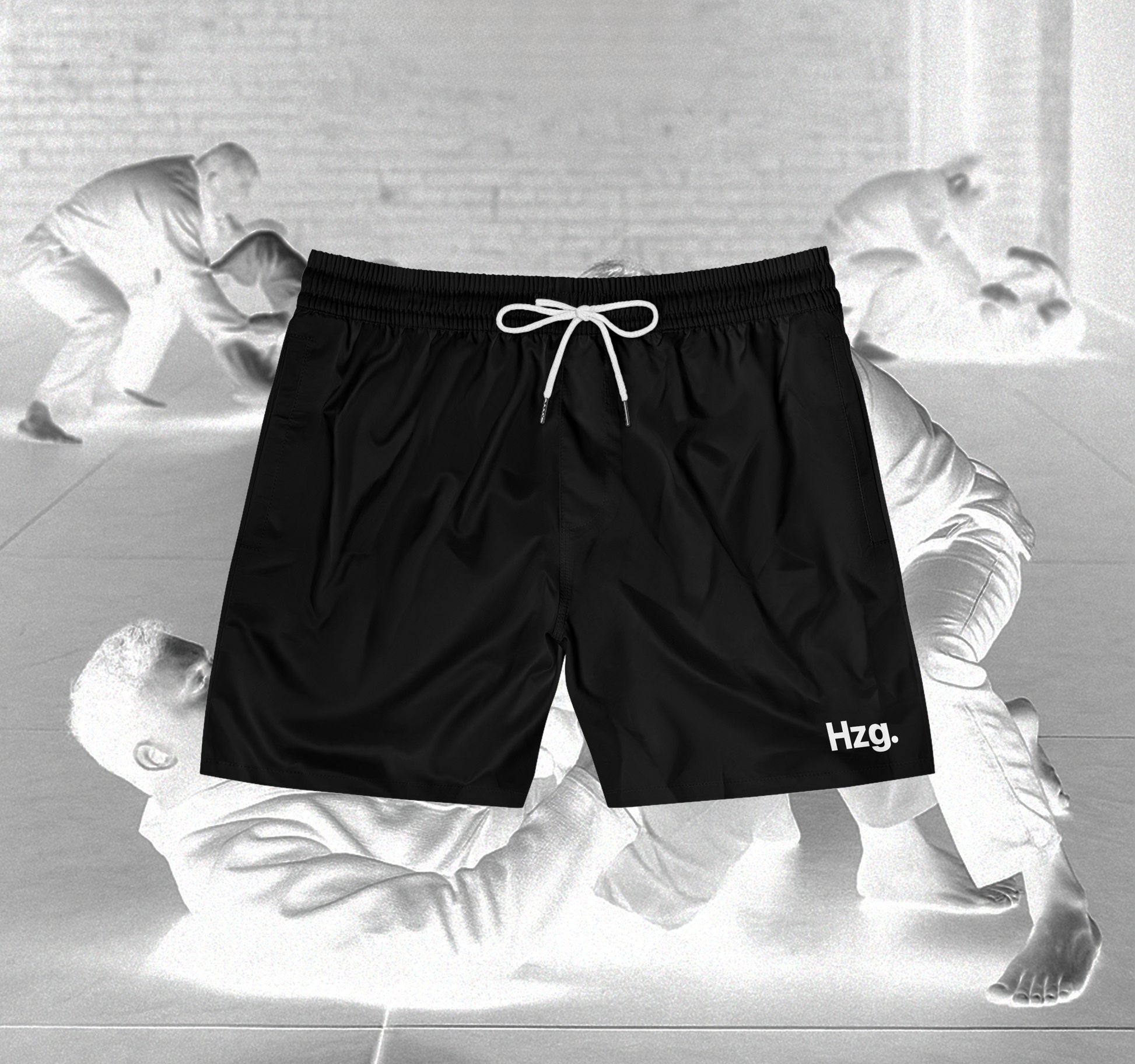 Black shorts with HZG logo on a background of black and white martial arts poses.