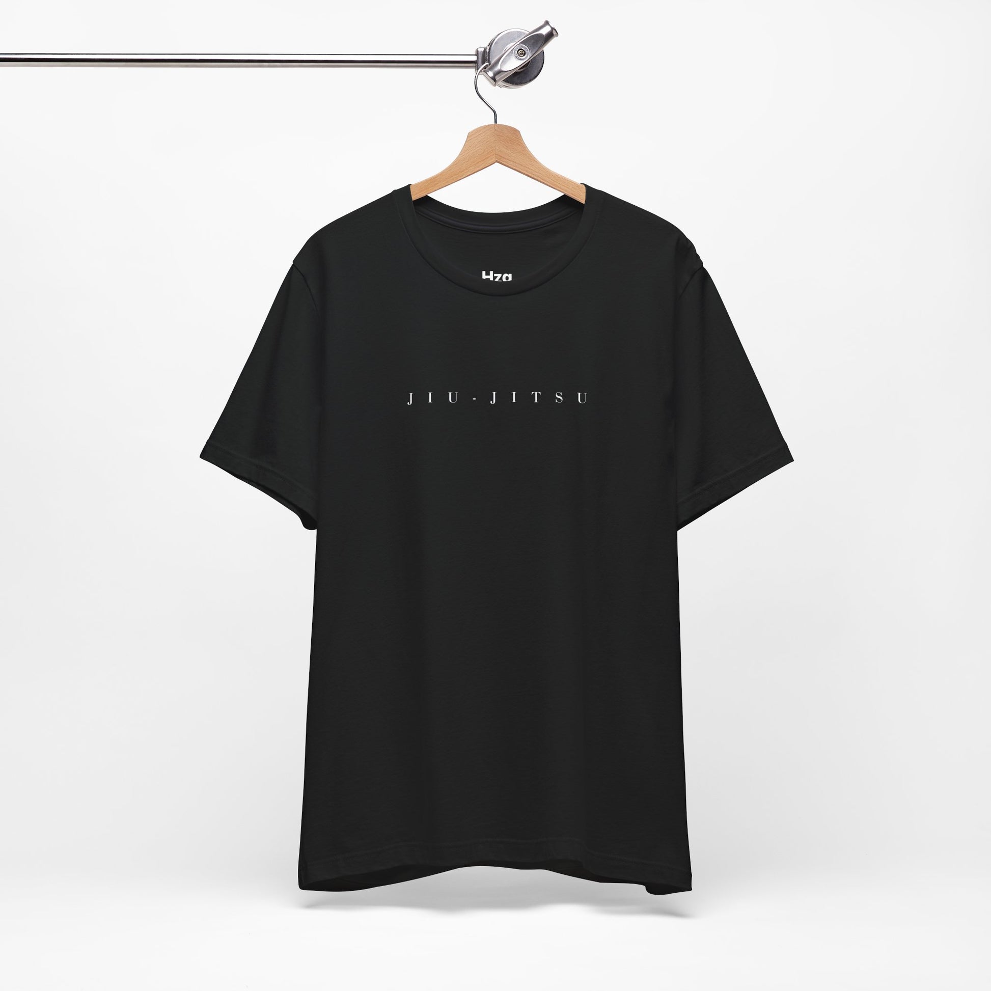 Black t-shirt with 'JIU-JITSU' text on a hanger against a white background